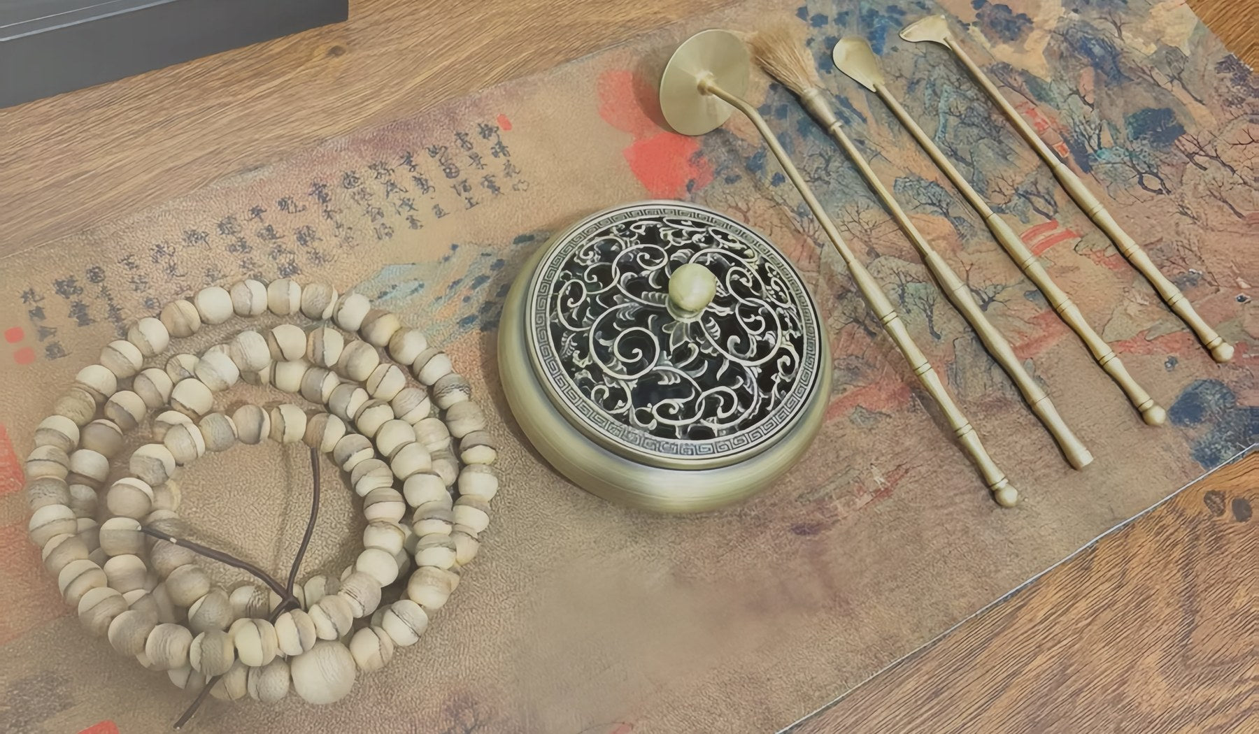 Seal incense starter tools arranged on a quiet tray with ash and mold details
